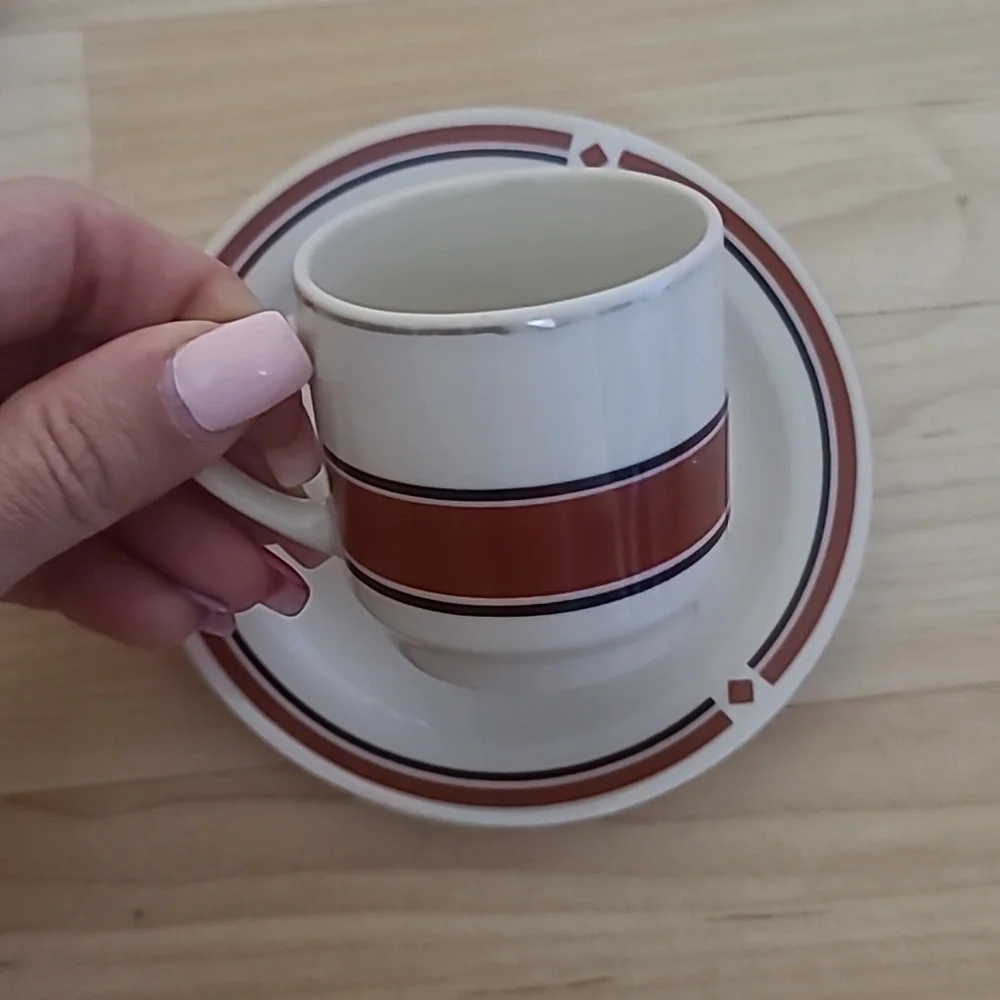 A set of 2 cups & saucers with red-maroon and black designs, and golden details
